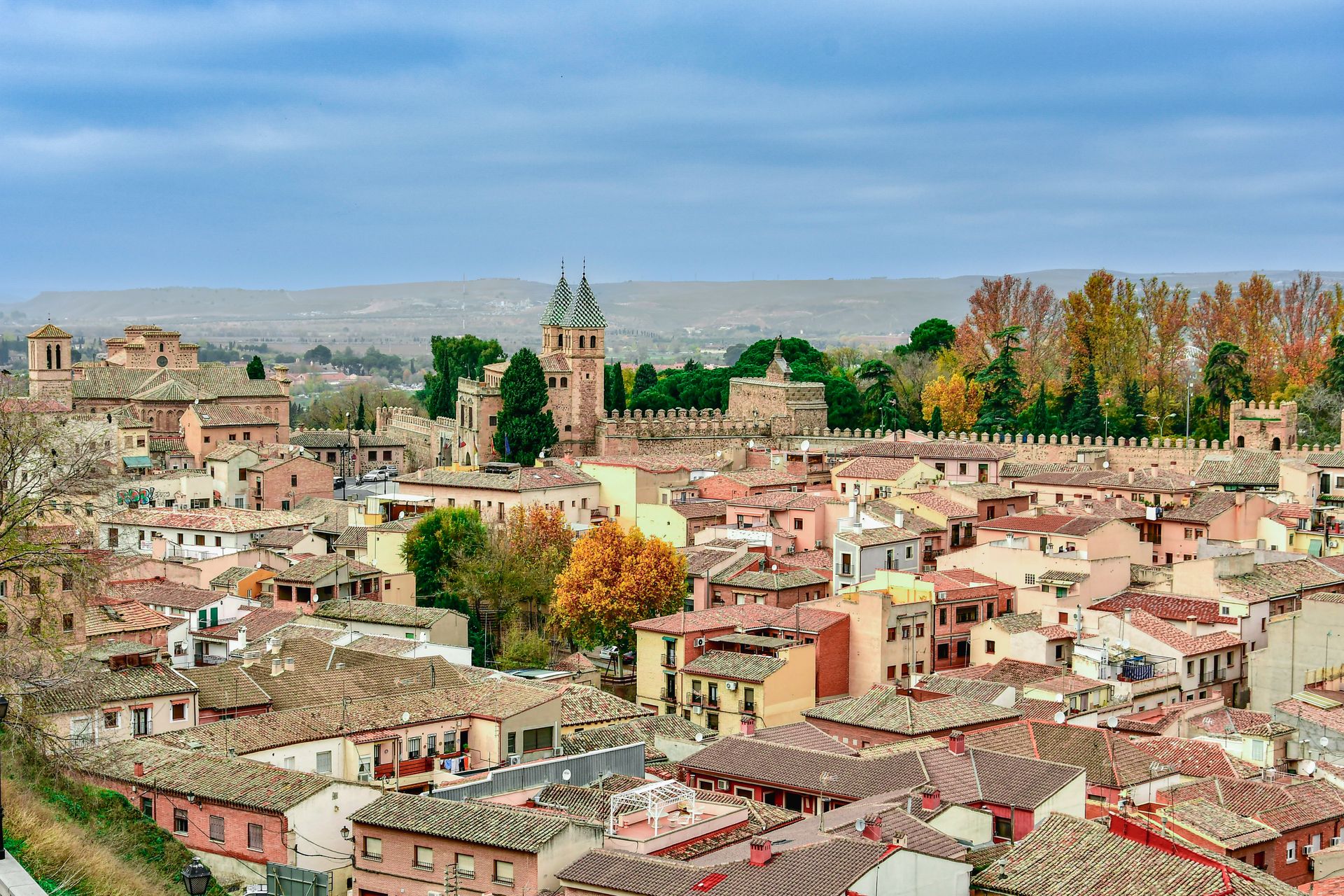 Picturesque aerial view of Toledo, Spain showcasing historic architecture against a vibrant landscape.