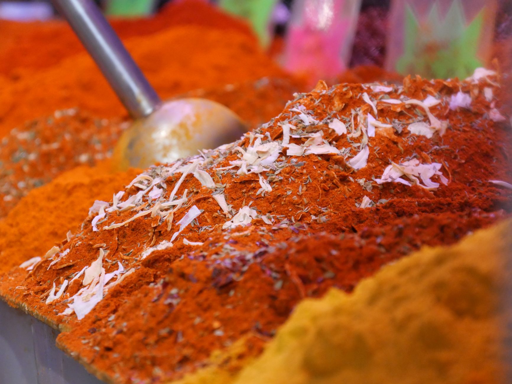 Mixing vegetables with garam masala spices in a bowl