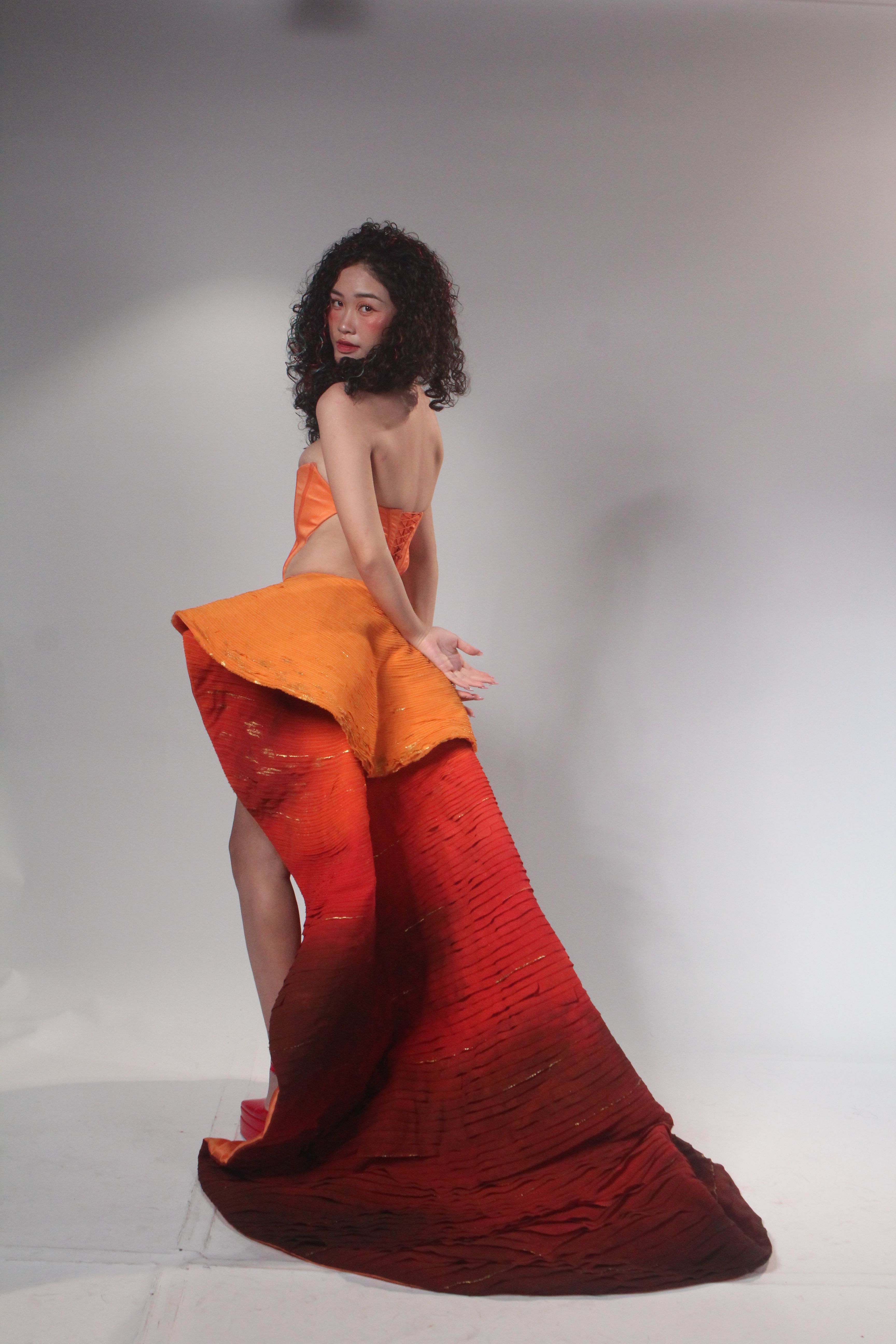 Elegant Fashion Model in Vibrant Red and Orange Gown · Free Stock Photo