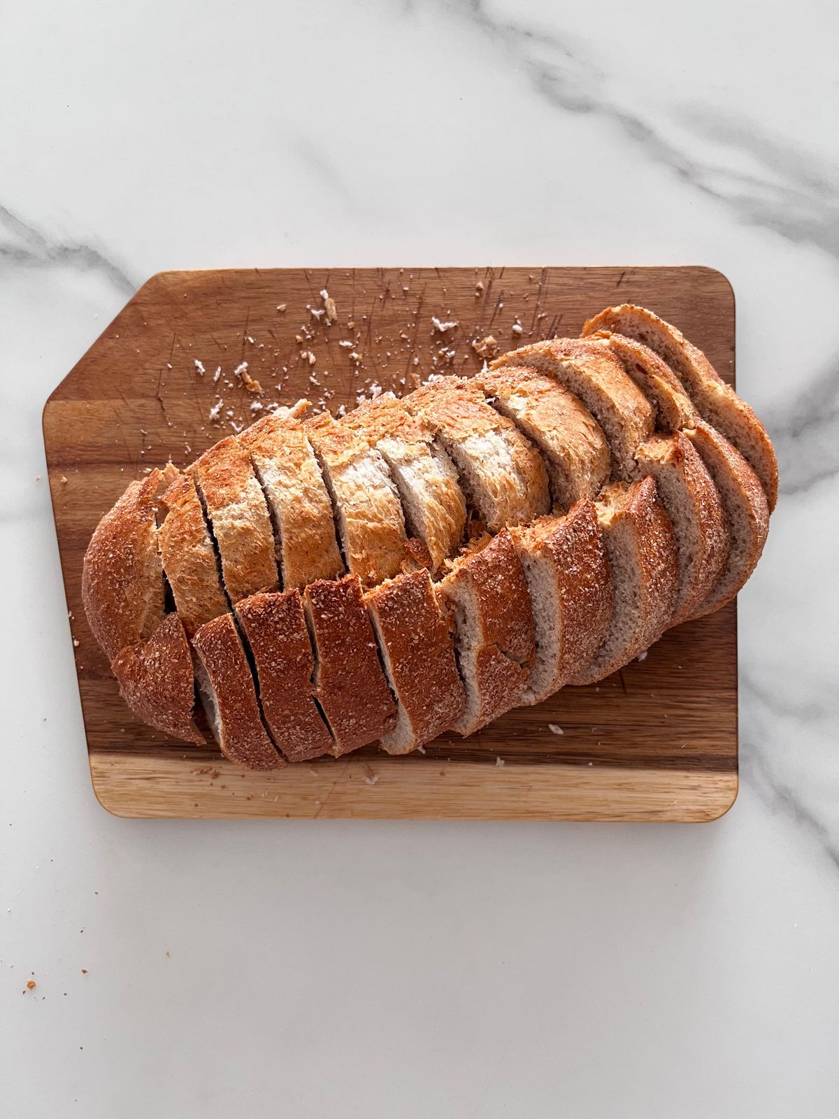 Freshly sliced homemade bread on a wooden cutting board