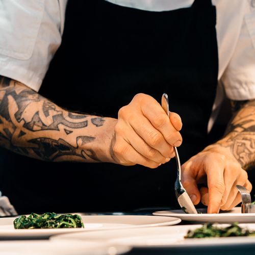 A cook's hands plating