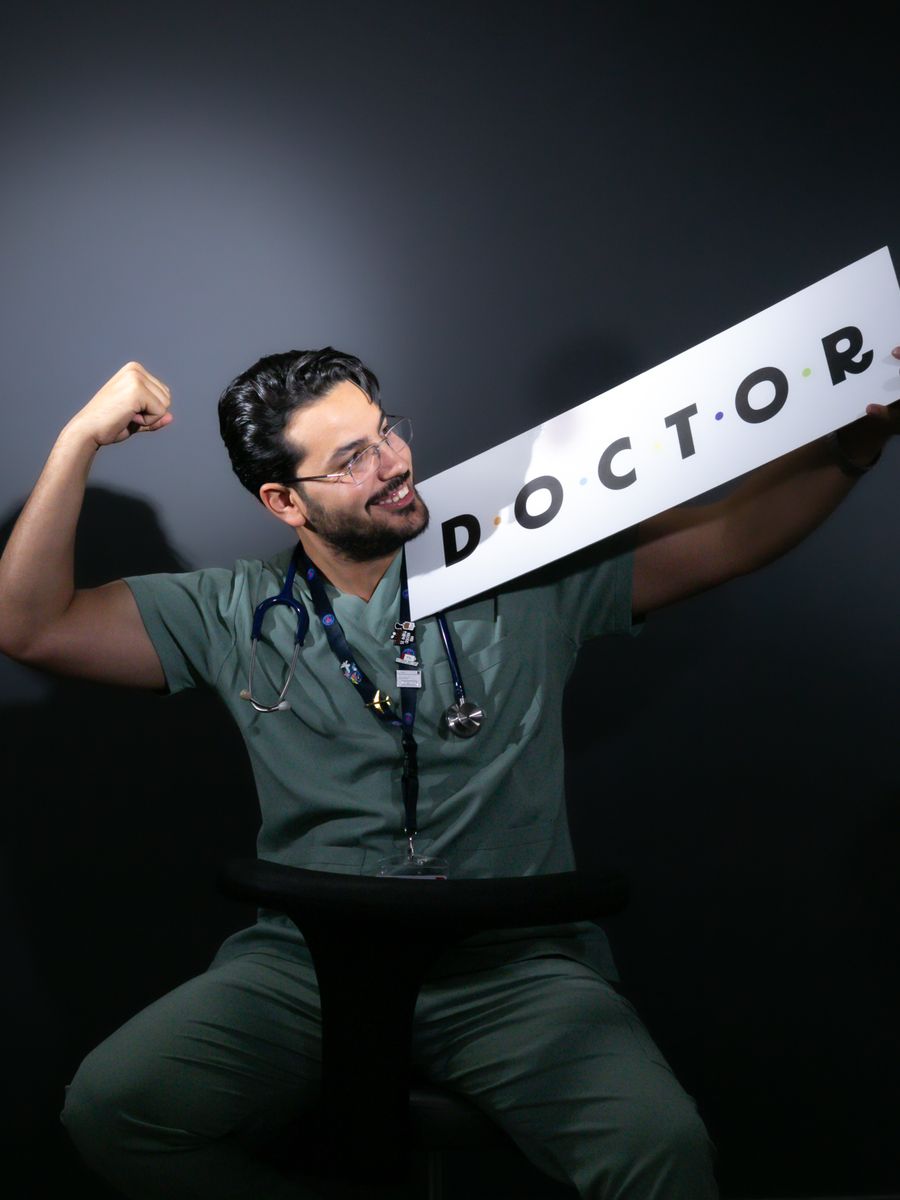 Male medical professional wearing royal blue scrubs