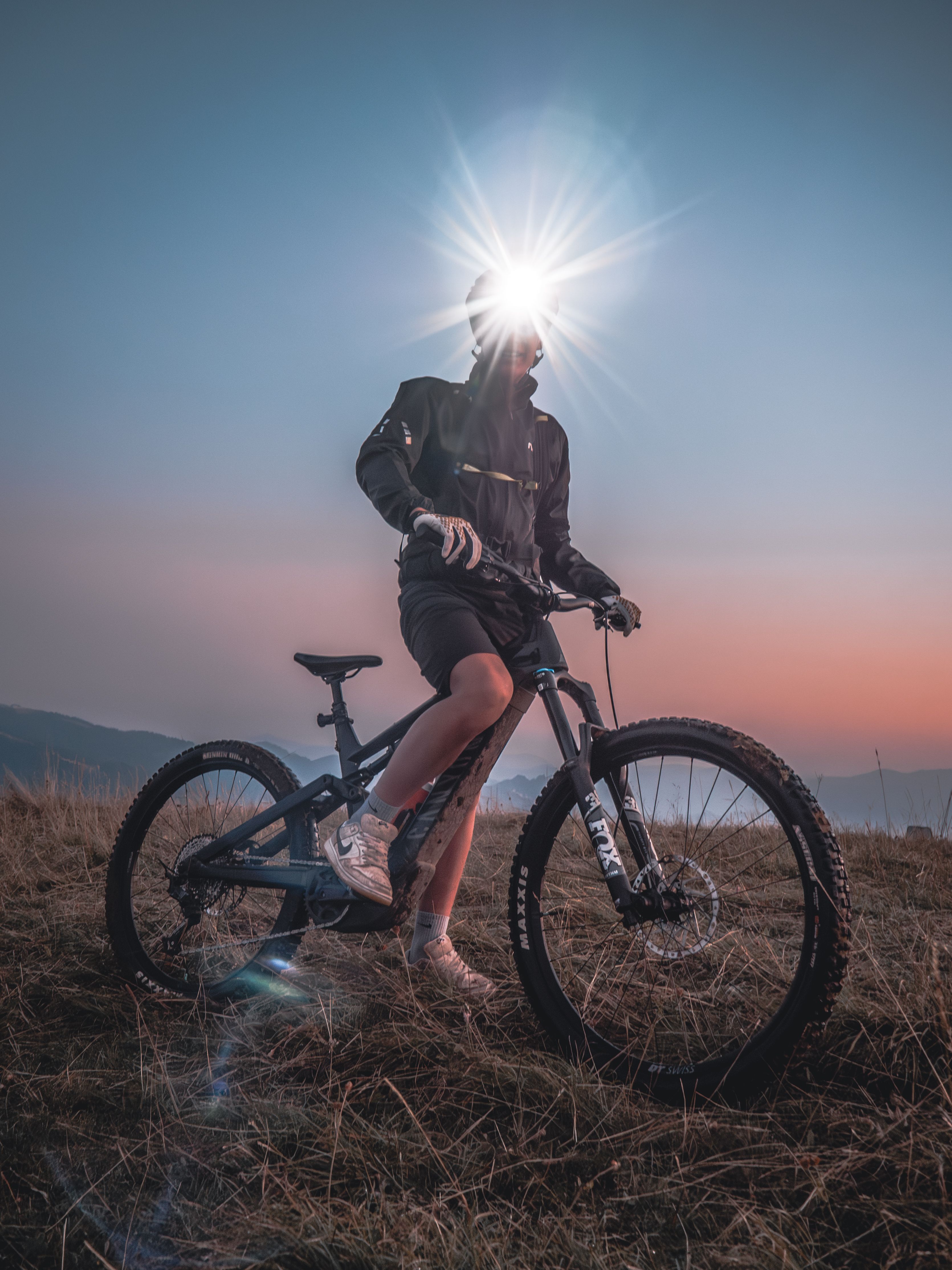 Silhouette of a mountain biker enjoying an adventurous ride at sunset.