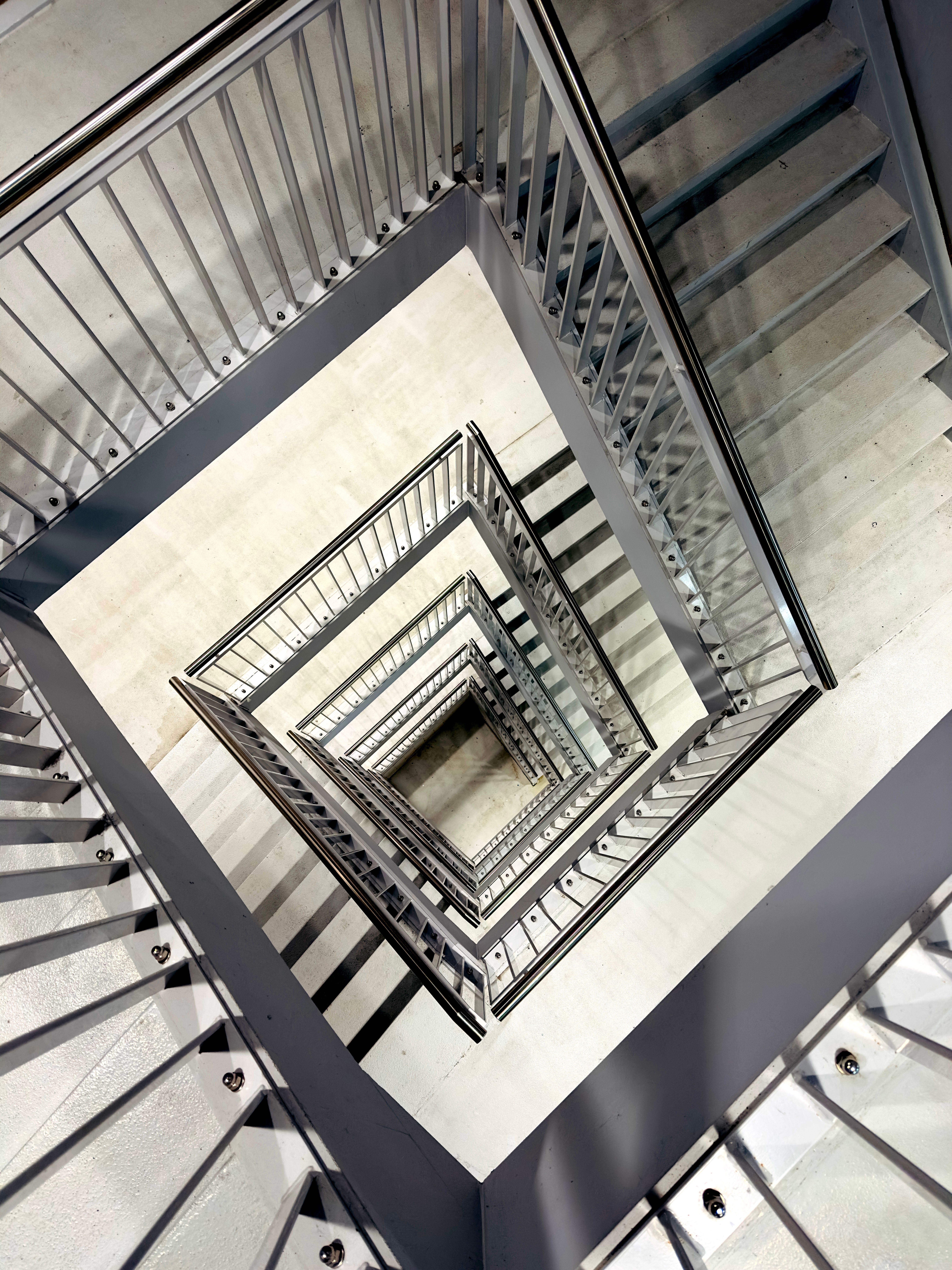 Spiral Staircase with Geometric Metal Railings · Free Stock Photo
