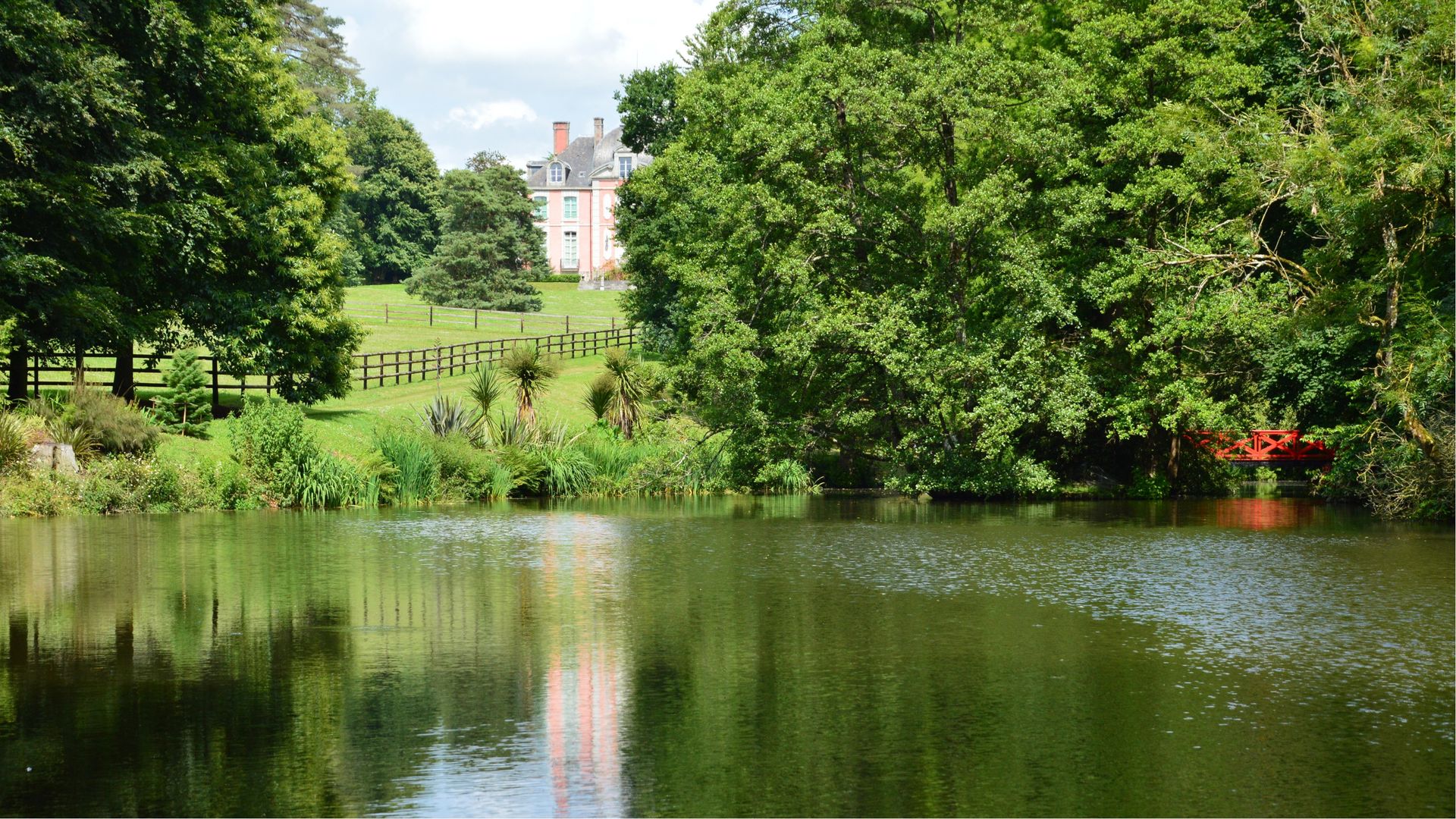 A picturesque lake with a lush garden estate in Bacilly, Normandie, France.
