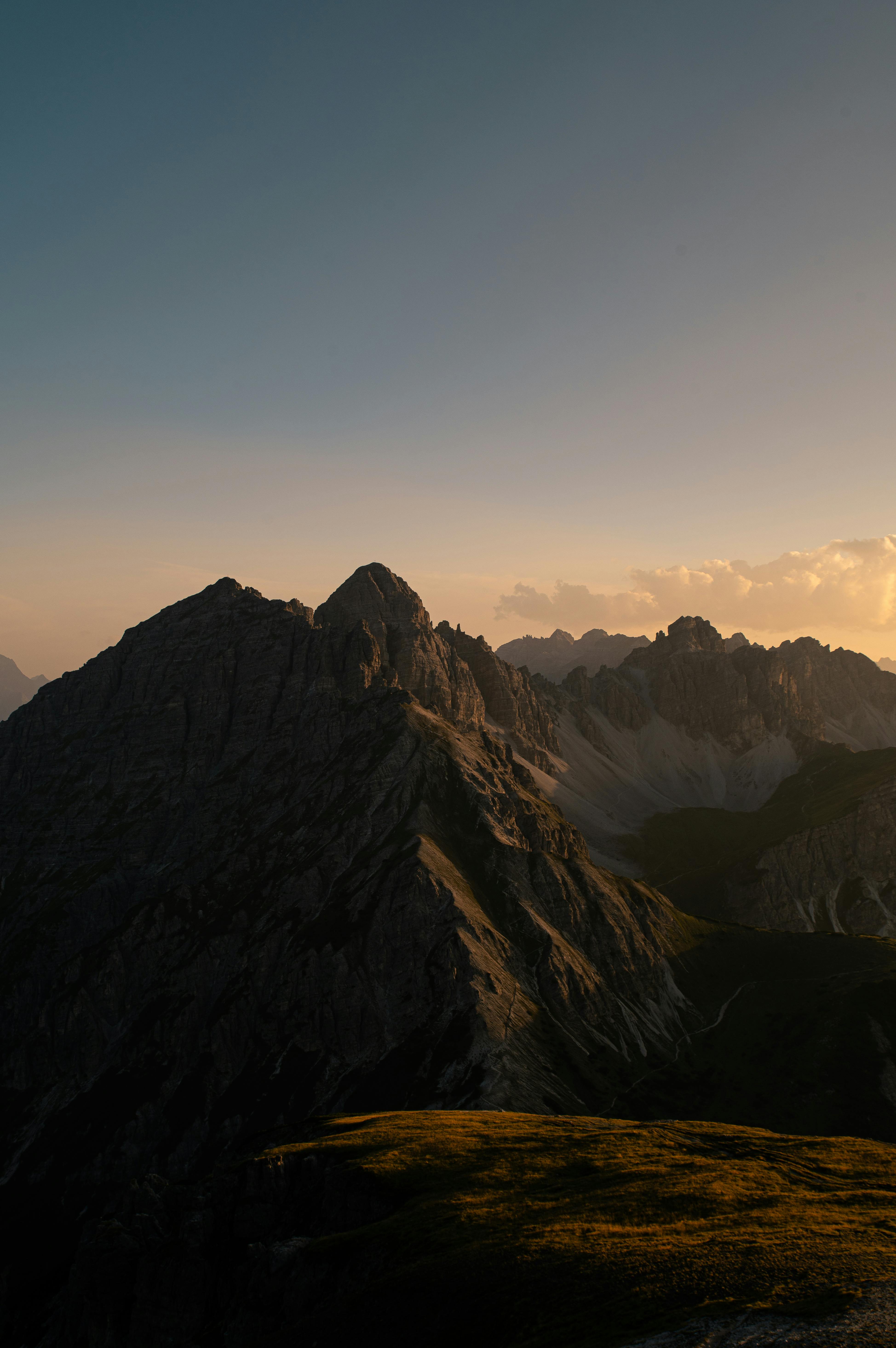Captivating view of the sun setting over the rugged peaks of the Tirol Alps in Austria.