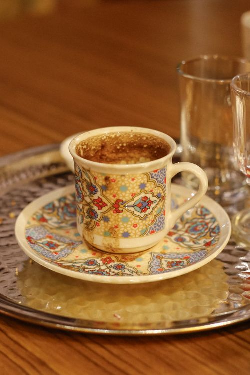 Free Colorful Turkish coffee cup with ornate design on a metal tray. Stock Photo