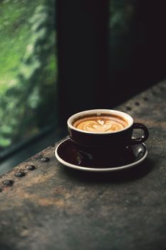 Serene close-up of a latte with intricate art, set in a cozy café. Perfect for coffee lovers.