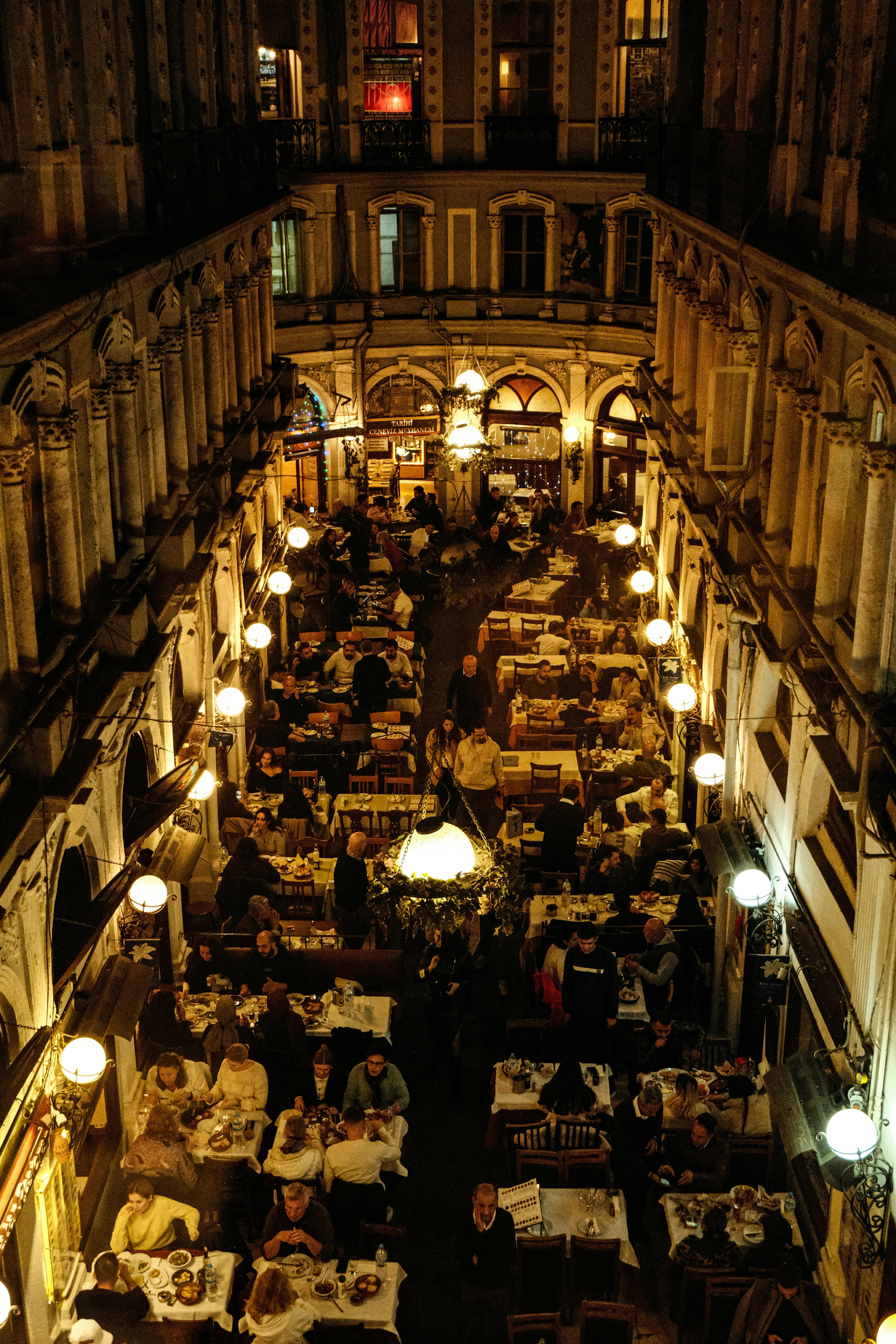 Elegant indoor dining scene in a historic arcade with vibrant ambiance.