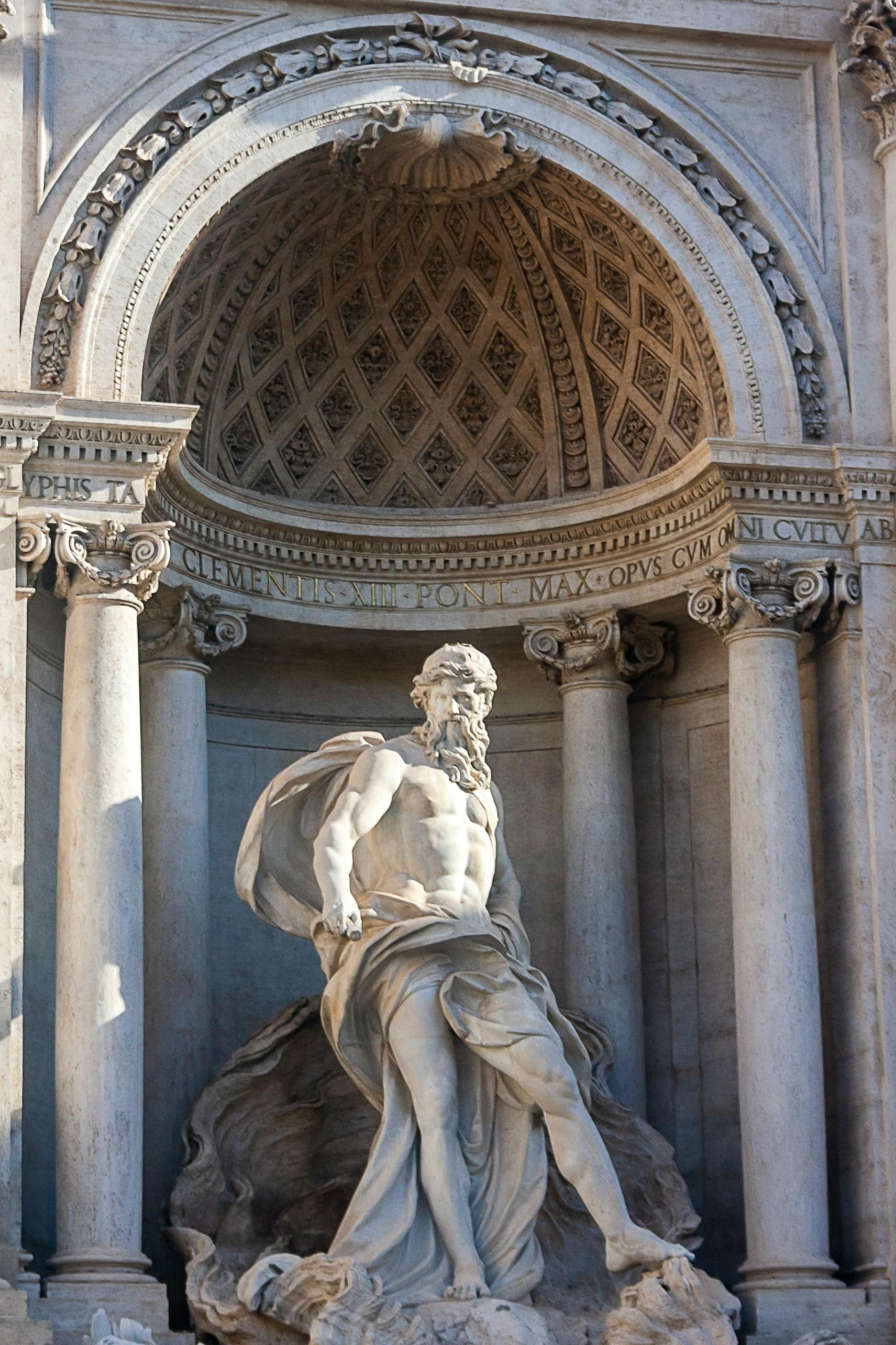 Renaissance marble statue in Rome, Italy, showcasing detailed craftsmanship and classical architecture.