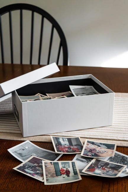 Old photographs in a worn shoebox — physical formats that outlasted their cameras