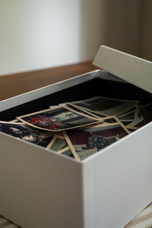 Box of printed family photographs ready for printing