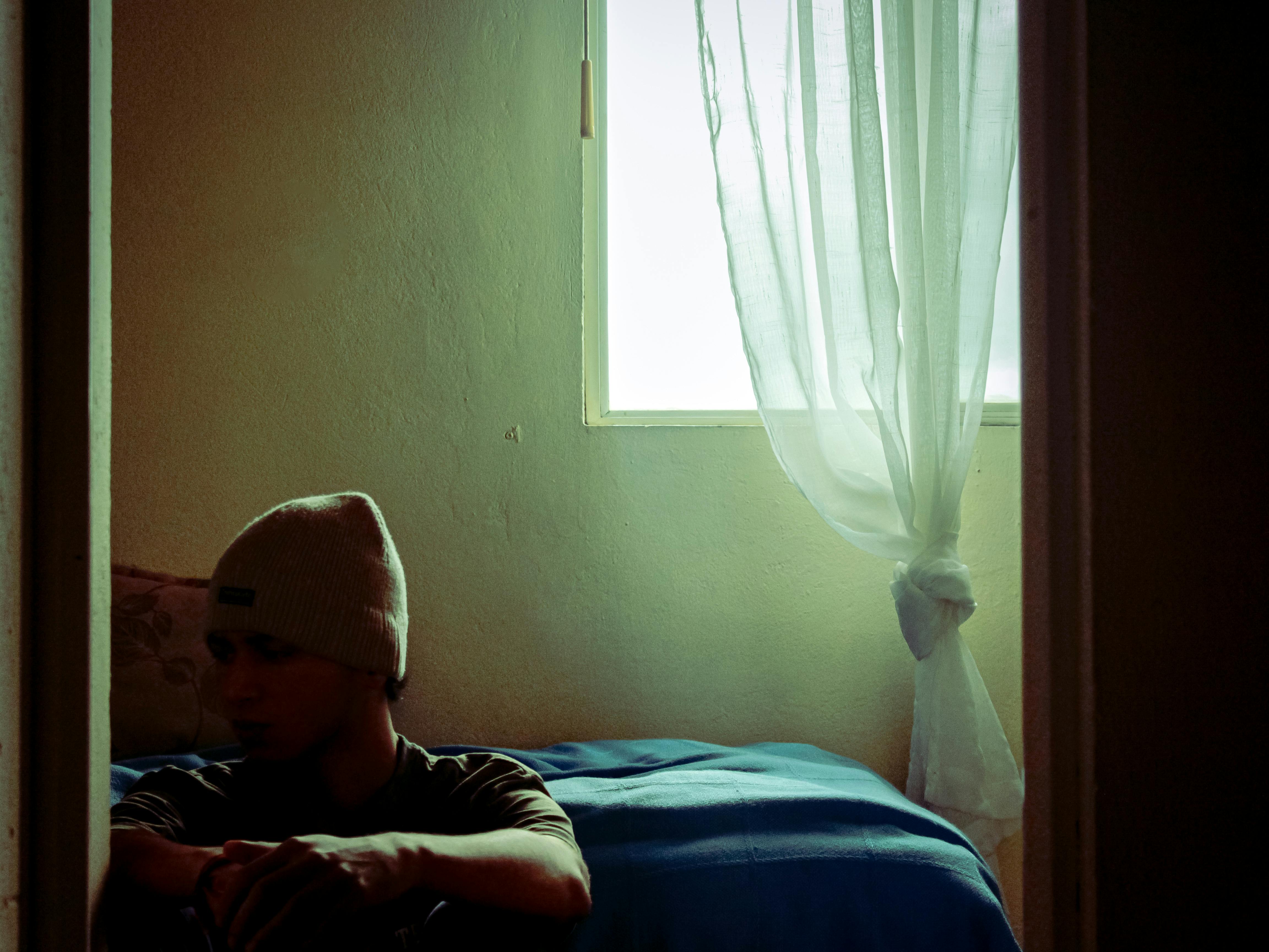 Sypialnia z zasłonami zaciemniającymi na sufitowej szynie