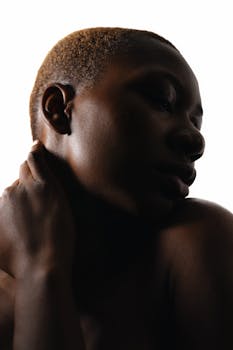 Artistic low-key portrait of a woman with creative backlighting.