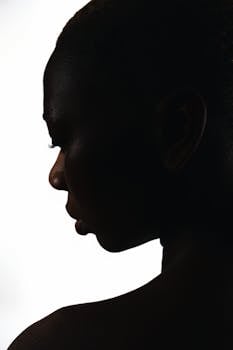 Elegant silhouette of a woman's profile against a white backdrop, highlighting beauty and elegance.
