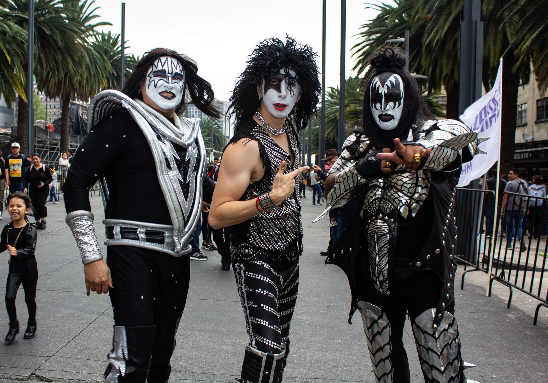 Fan gathering with people in rock band costumes in Mexico City.