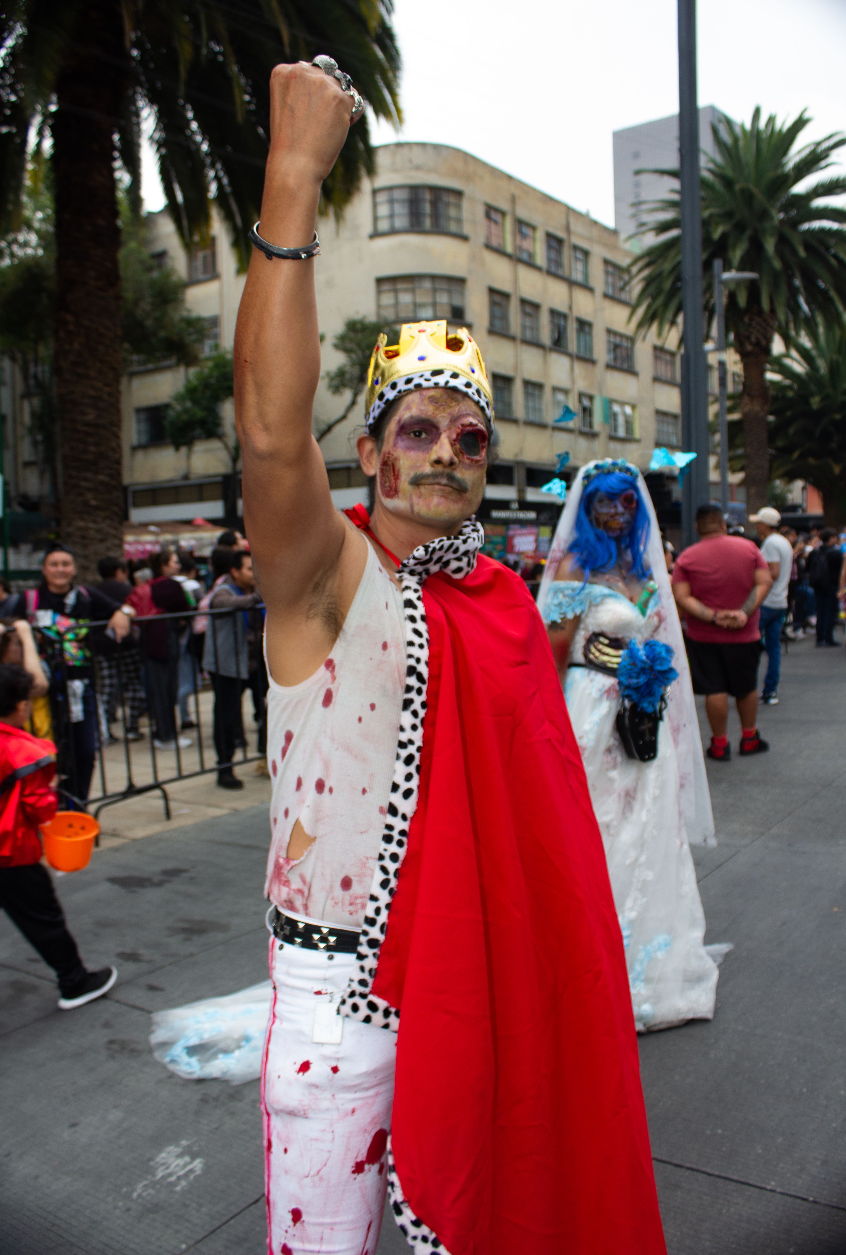 Vibrant parade participants in creative costumes celebrating on the streets of Mexico City.