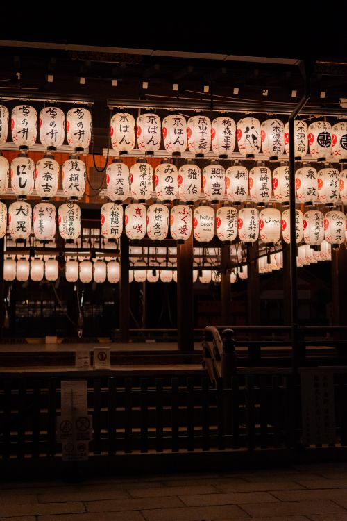 Free A night scene of lit Japanese lanterns hanging in a festive outdoor setting. Stock Photo