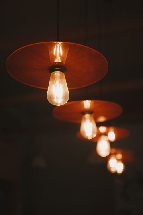 Free Close-up of vintage hanging light bulbs creating a warm ambiance indoors. Stock Photo