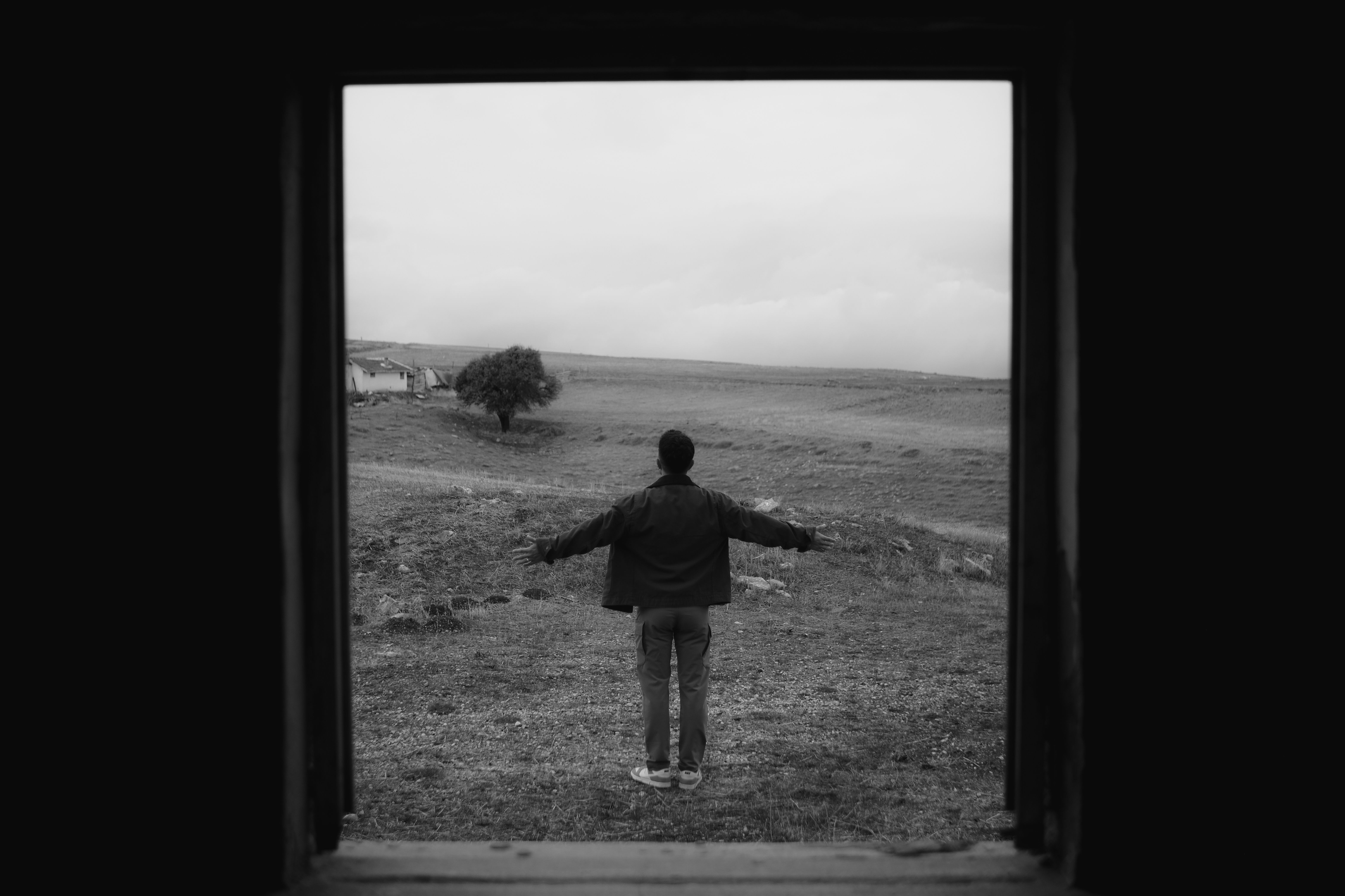 Person from behind standing still in large open Sardinian landscape