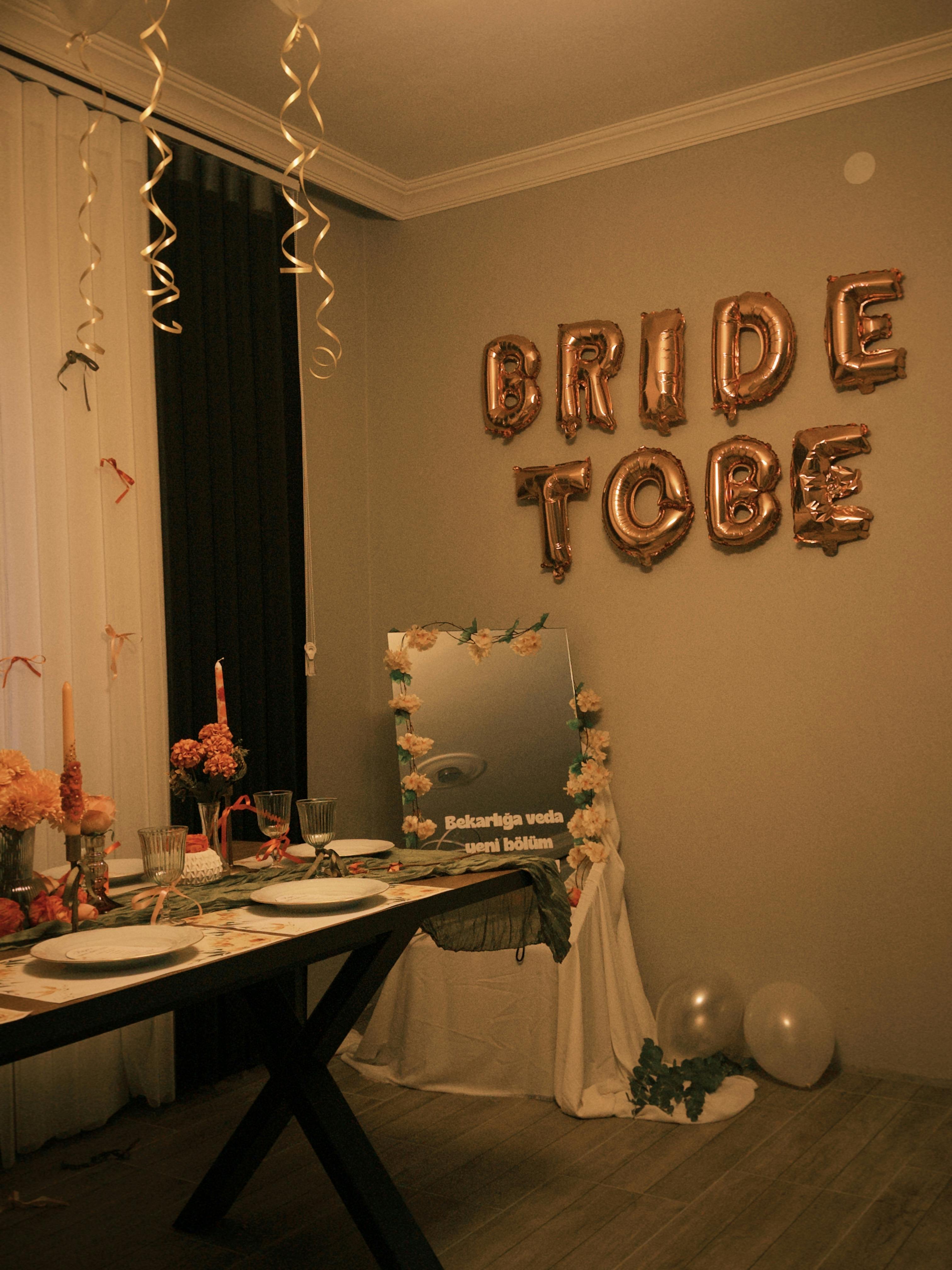 Charming indoor setup for a bride-to-be event featuring decorative balloons and elegant table settings.