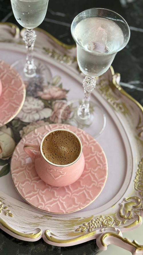 Free Pink coffee cup with bubbly champagne on vintage floral tray. Stock Photo