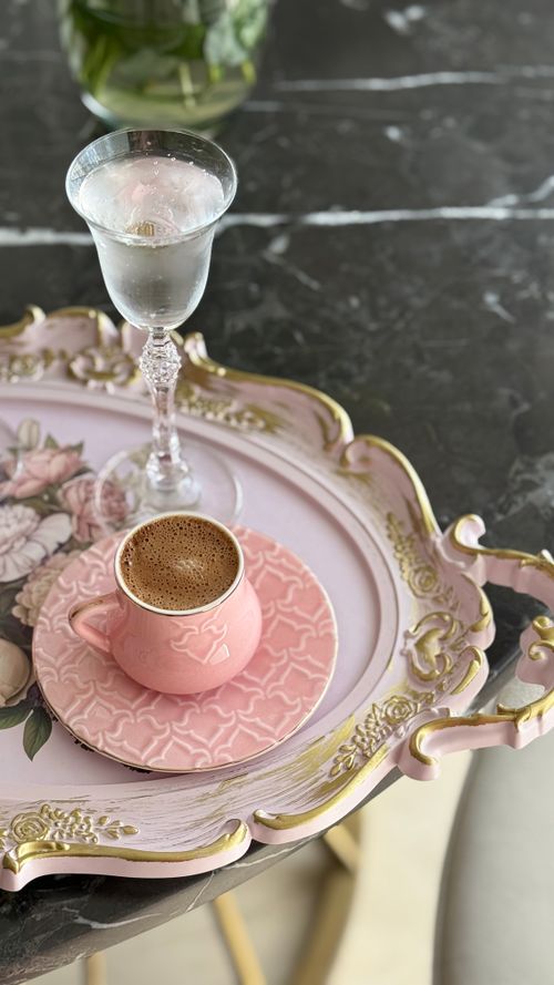 Free A stylish coffee cup and glass of water on a decorative floral tray. Stock Photo