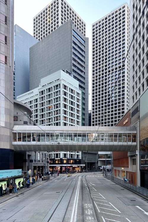 Free A vibrant view of modern skyscrapers and a pedestrian bridge in Central Hong Kong's bustling cityscape. Stock Photo