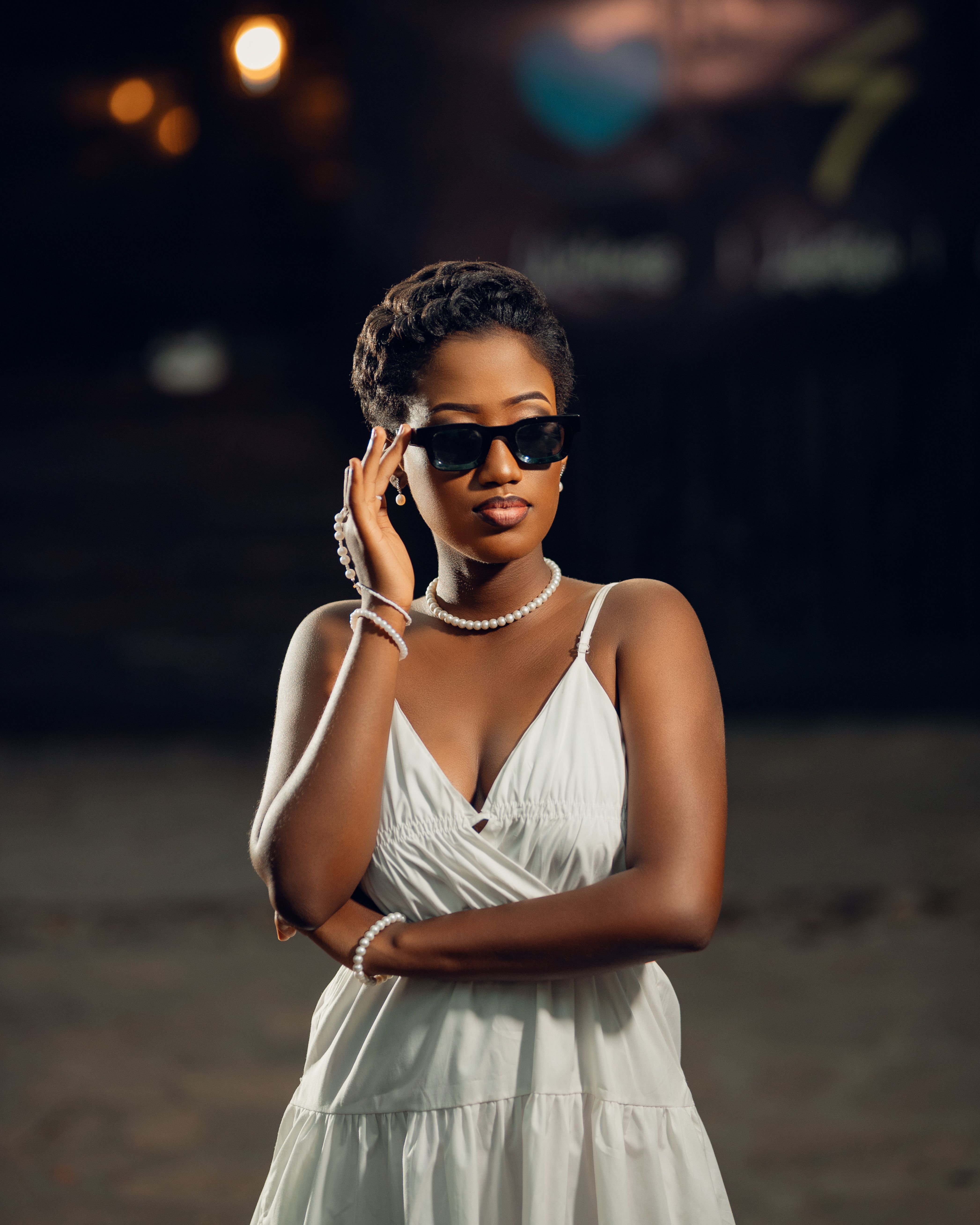 Elegant Woman in White Dress Wearing Sunglasses  Free Stock Photo