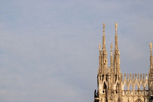 Close-up of Duomo di Milano spires on a clear day, Italy's iconic Gothic cathedral.