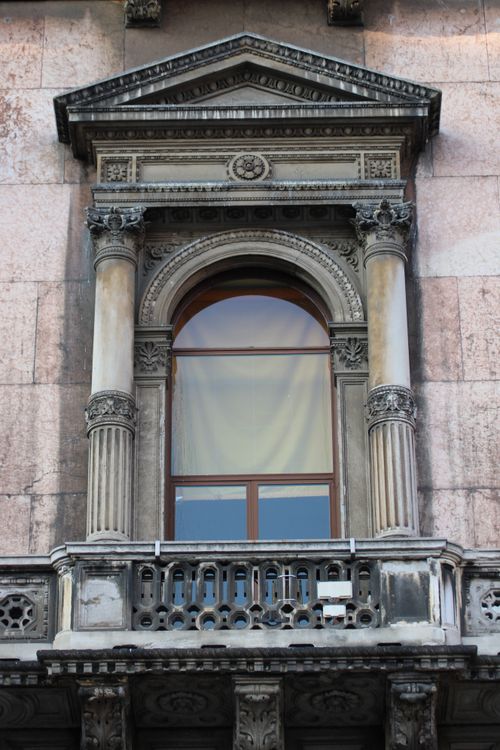 Free An ornate historic window in Milan showcasing Renaissance architectural details. Stock Photo