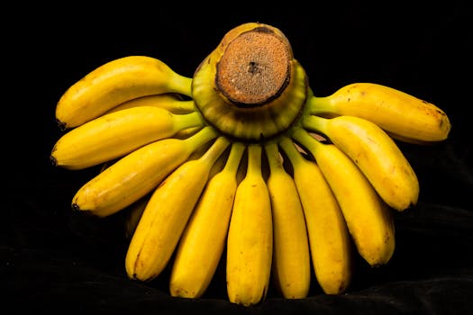 Vivid bananas displayed on a dark background, showcasing vibrant yellow hues.