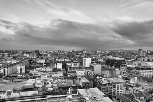 Black and white aerial photograph capturing the expansive cityscape of Glasgow, Scotland.