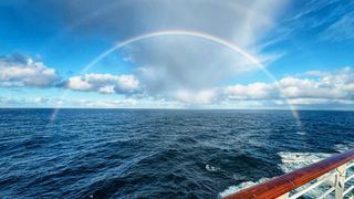 Wide rainbow over open water, photo by DSD on Pexels
