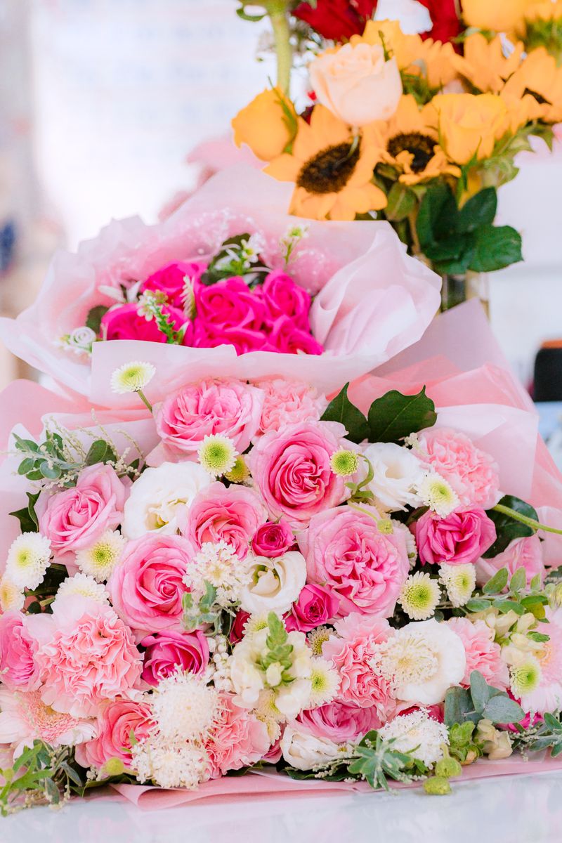 Lush bouquet of pink roses and mixed flowers, perfect for celebrations.