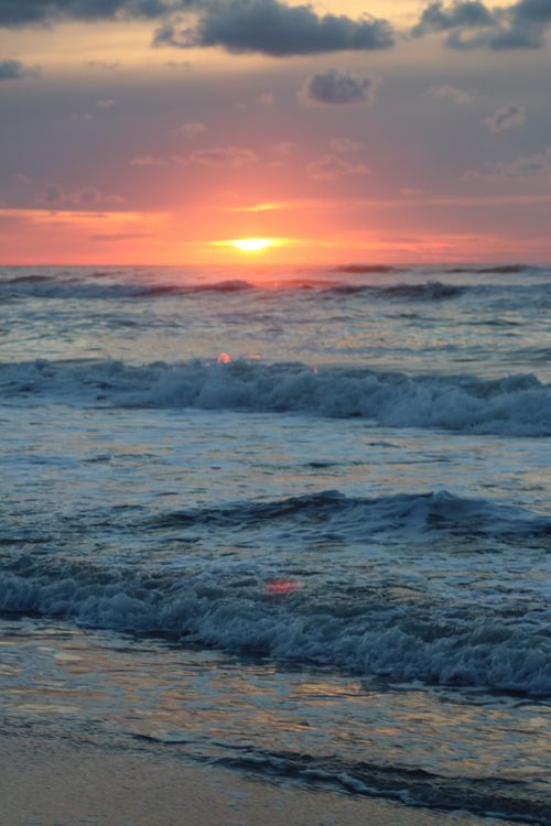 Free Stunning ocean sunset with vibrant colors over the North Sea in Friesland, Netherlands. Stock Photo