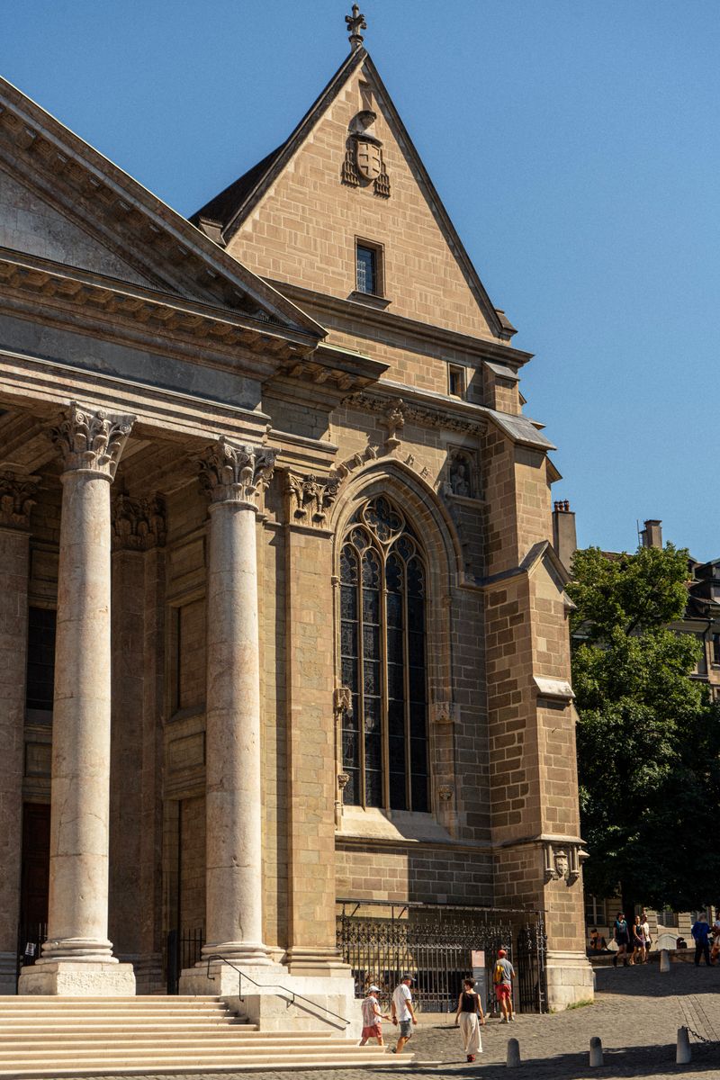 St Pierre Cathedral facade with columns under a clear blue sky in Geneva