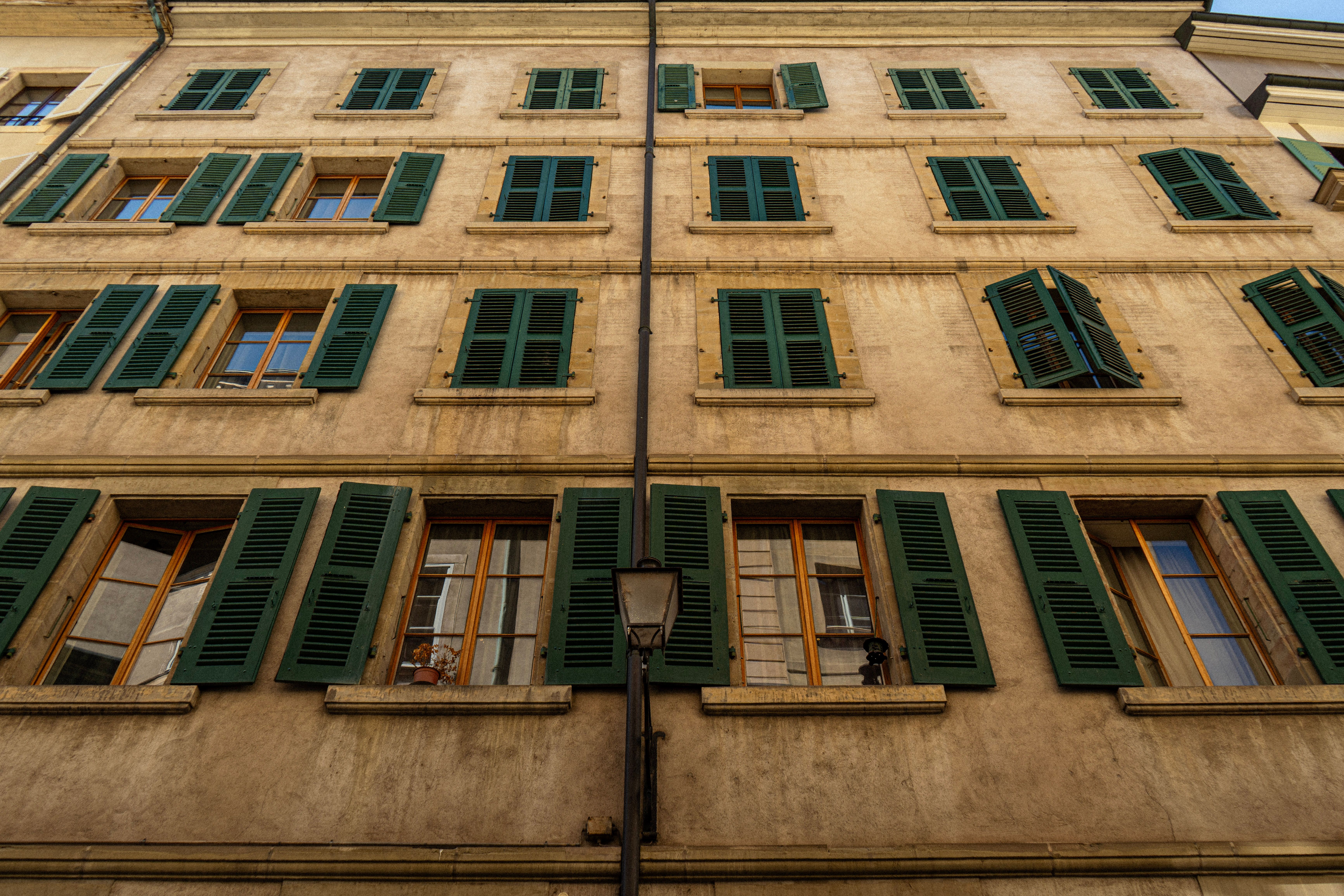Pastel facade with green shutters in Carouge — most photogenic Geneva neighborhood