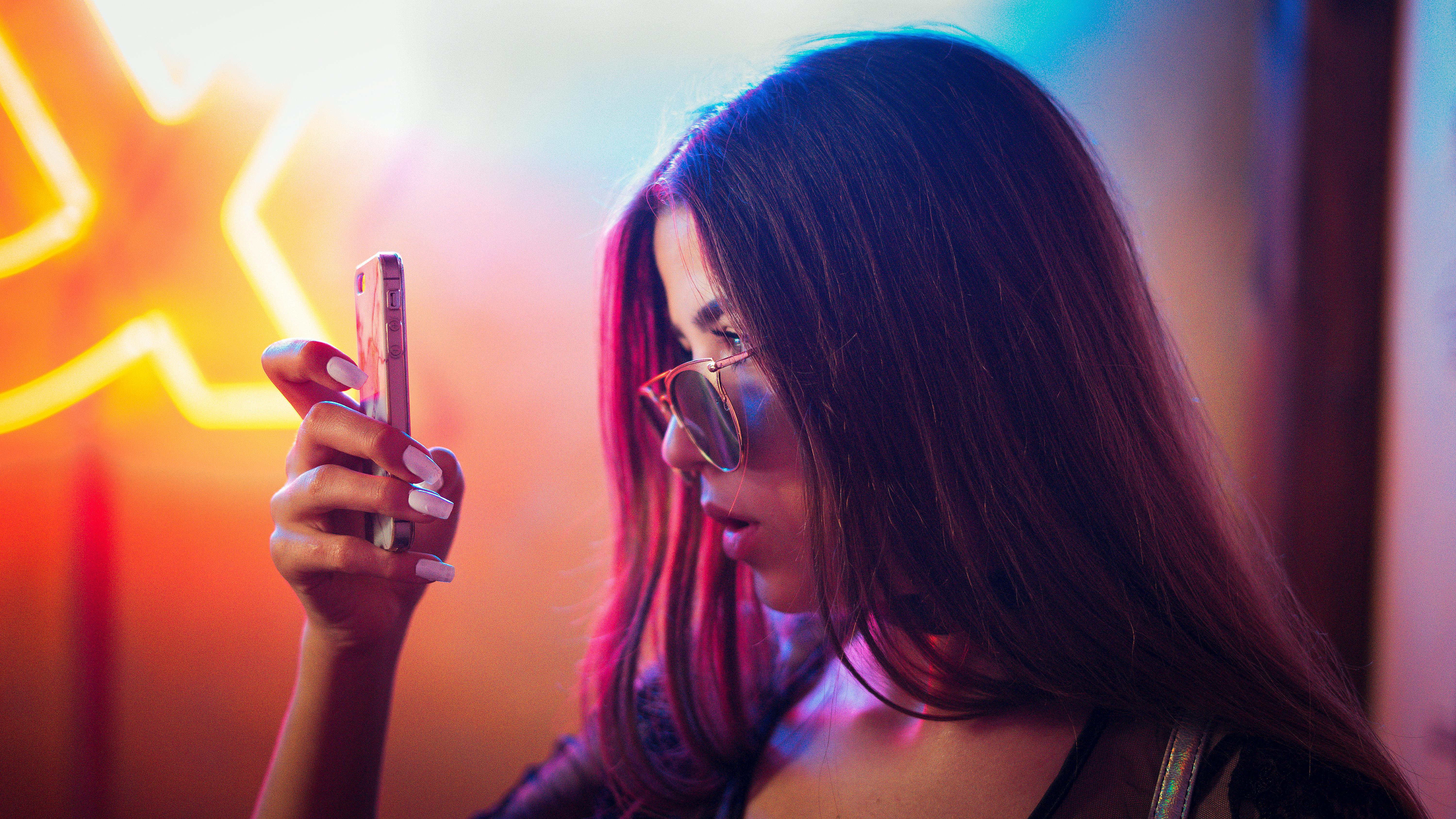 photo of woman holding phone