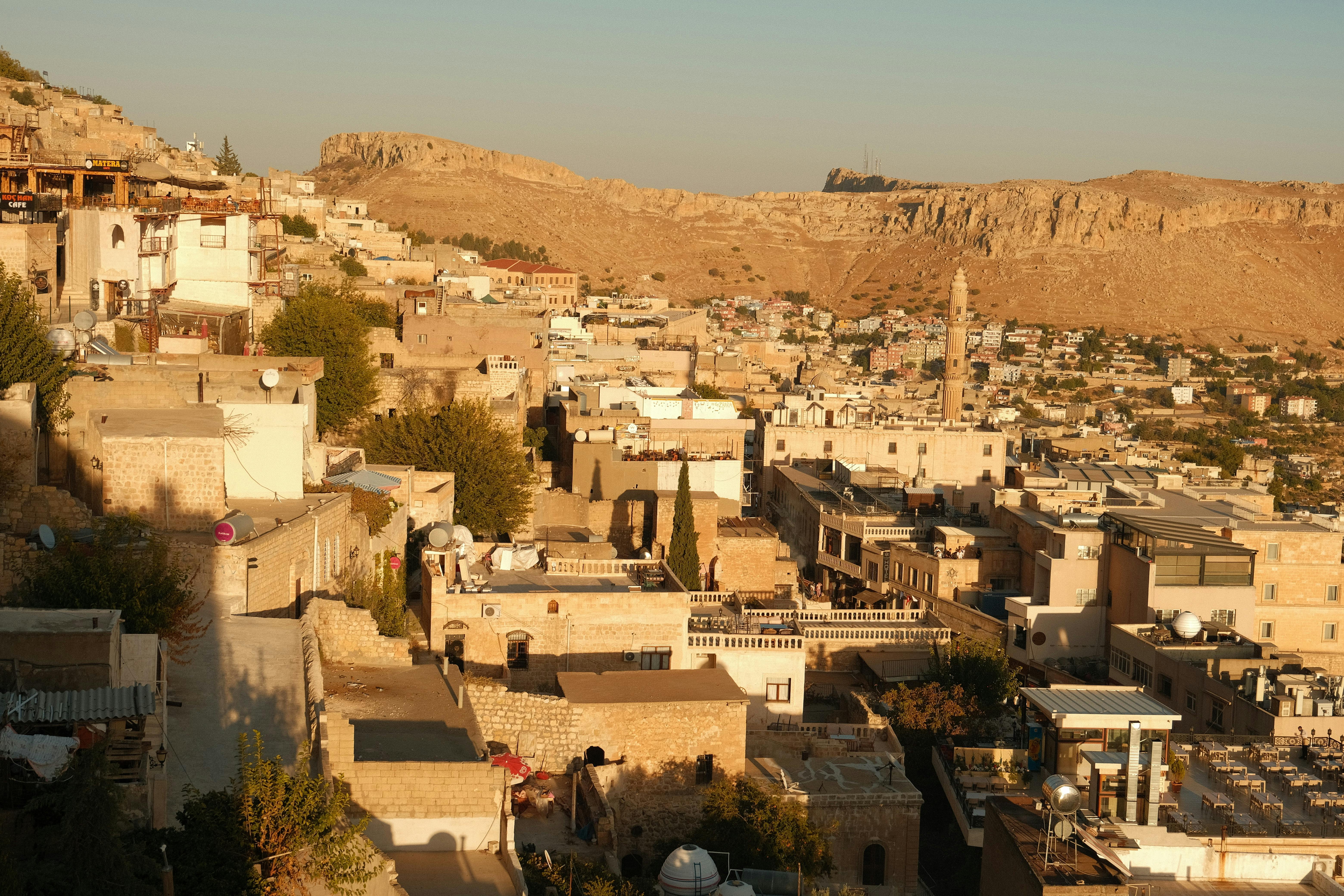 Discover the stunning stone architecture of Mardin, Türkiye, from above, illuminated by warm sunlight.