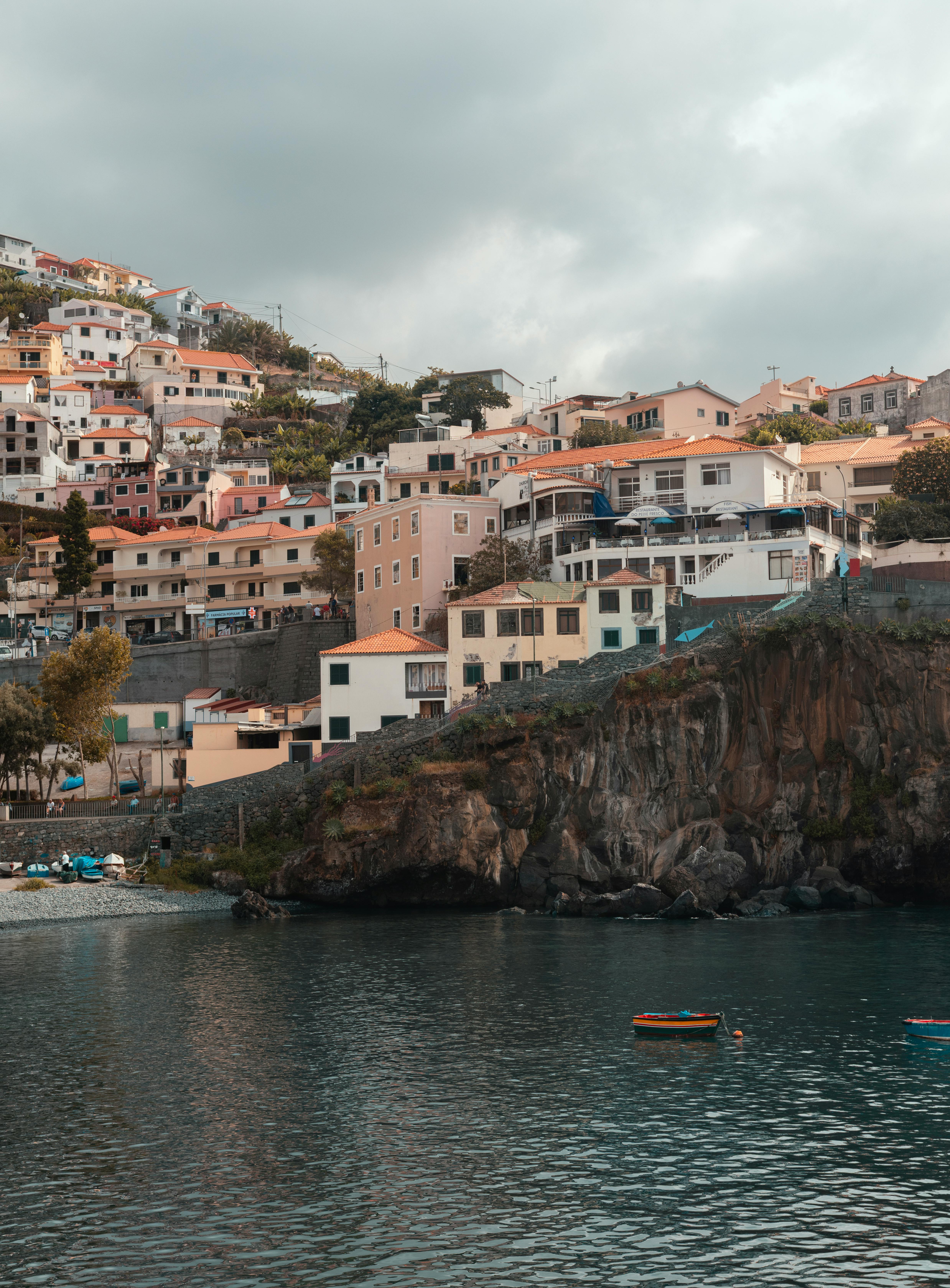 Charming coastal village with colorful houses on a cliffside in Madeira, Portugal.