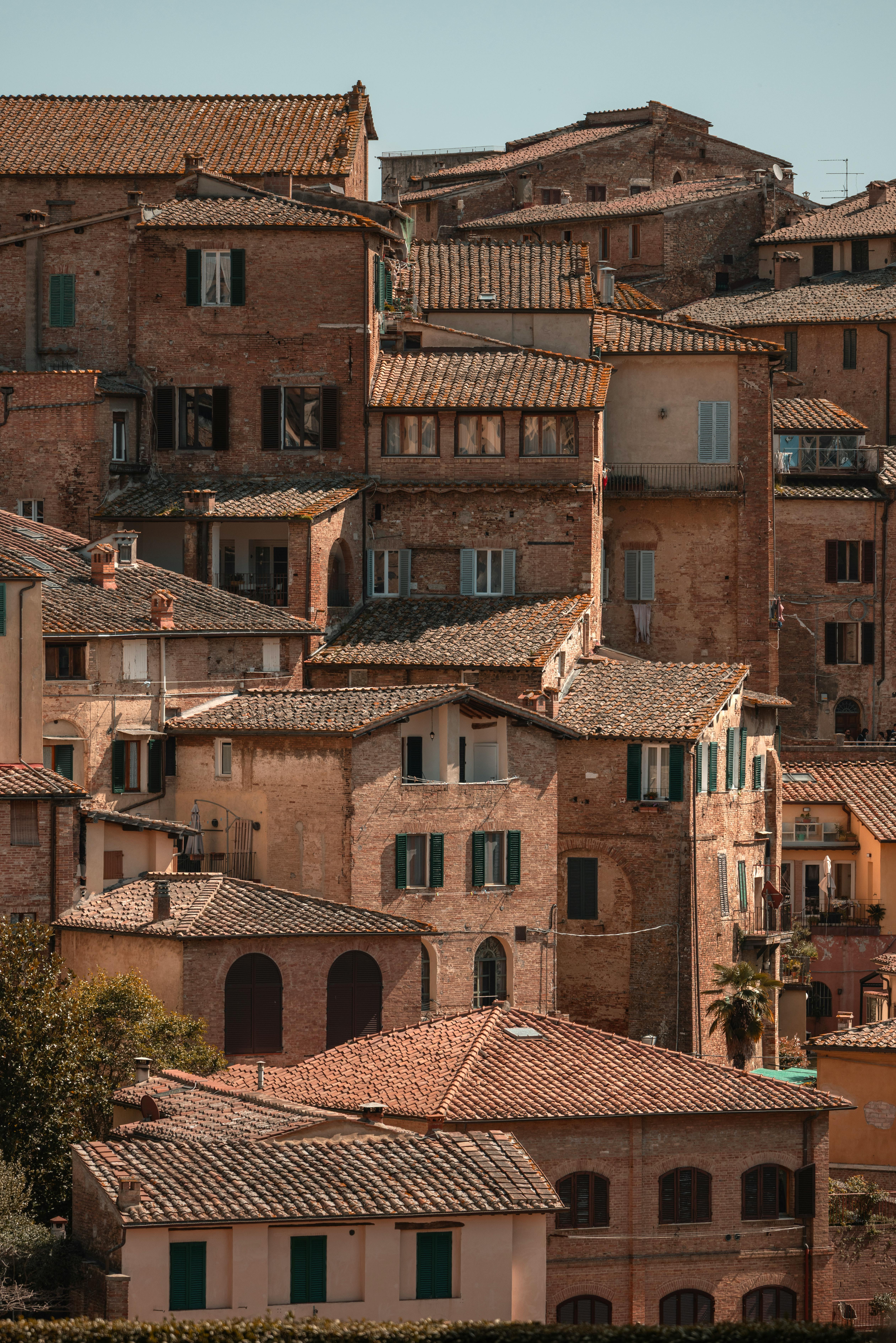 Rustic Tuscan buildings in Siena, showcasing historic architecture and warm tones.