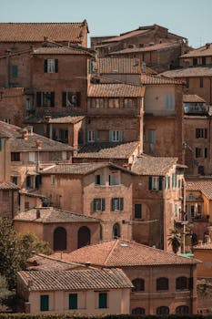 Rustic Tuscan buildings in Siena, showcasing historic architecture and warm tones.