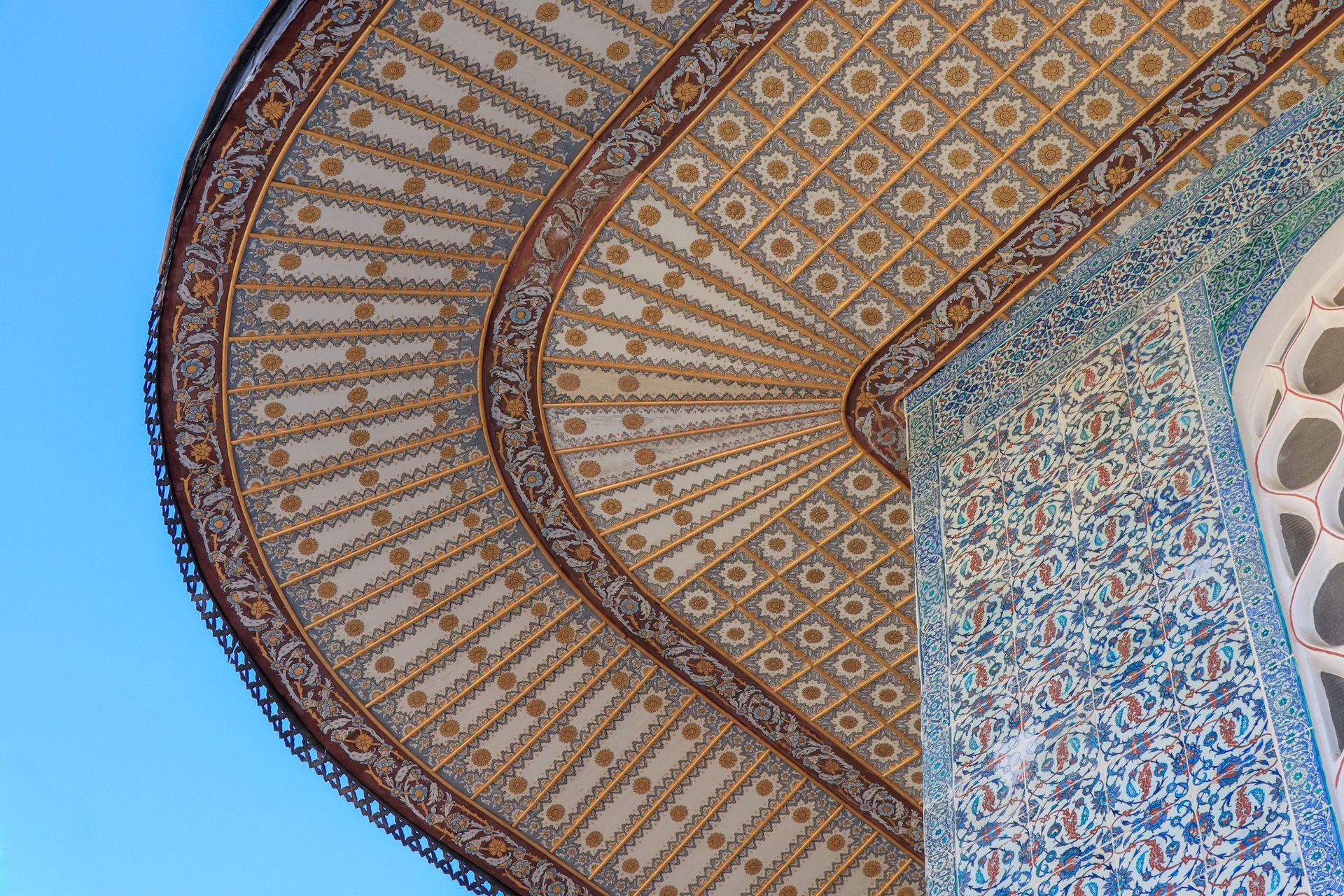 Intricate architectural ceiling with geometric and ornate designs in bright daylight.