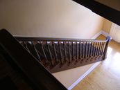 Brown Wooden Stairs in Front of White Wooden Door