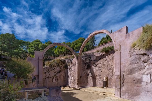 Majestic historical arches under a vibrant blue sky in Alicante, Spain.