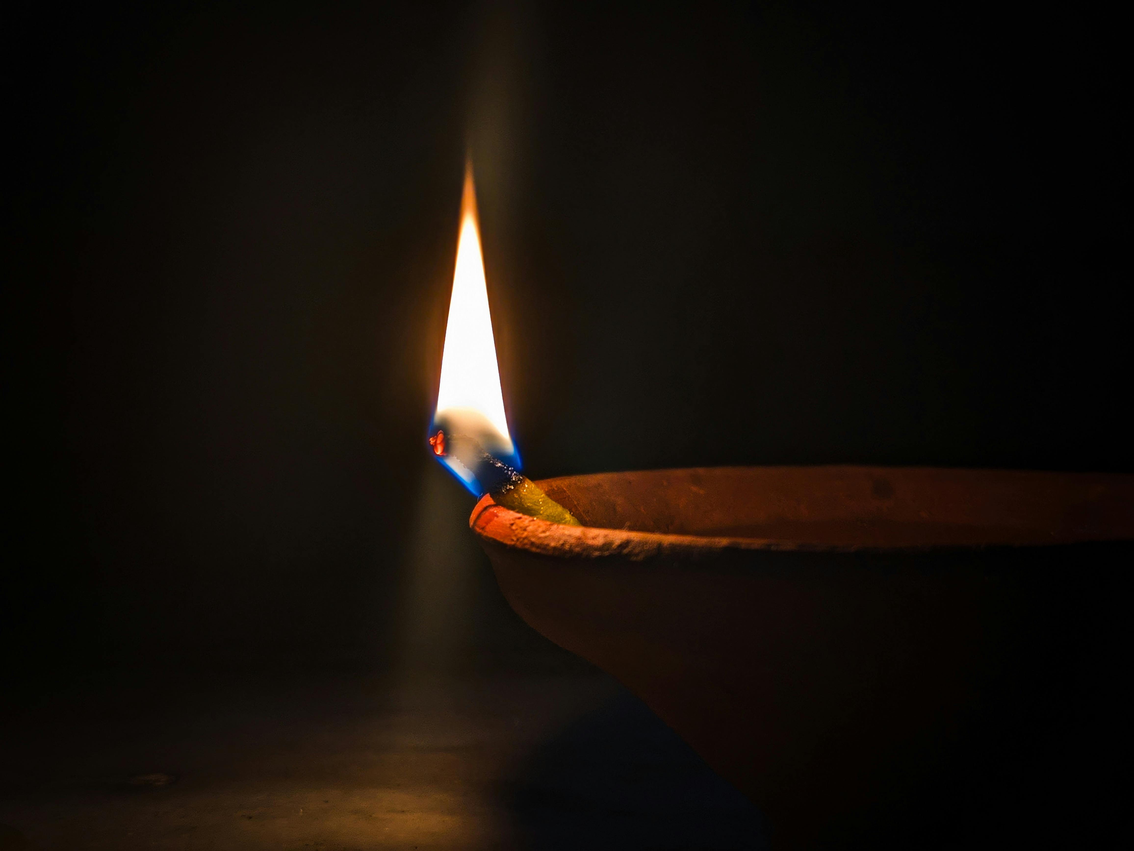 Lit diya lamp casting warm glow representing Vastu energy balance