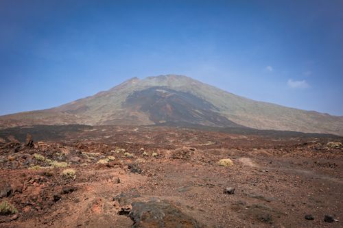 Free A stunning volcanic mountain under clear blue skies in a barren landscape. Stock Photo