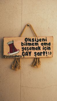 A humorous wooden sign about tea, essential for life, slightly funny message. — photo by Yasin Onuş