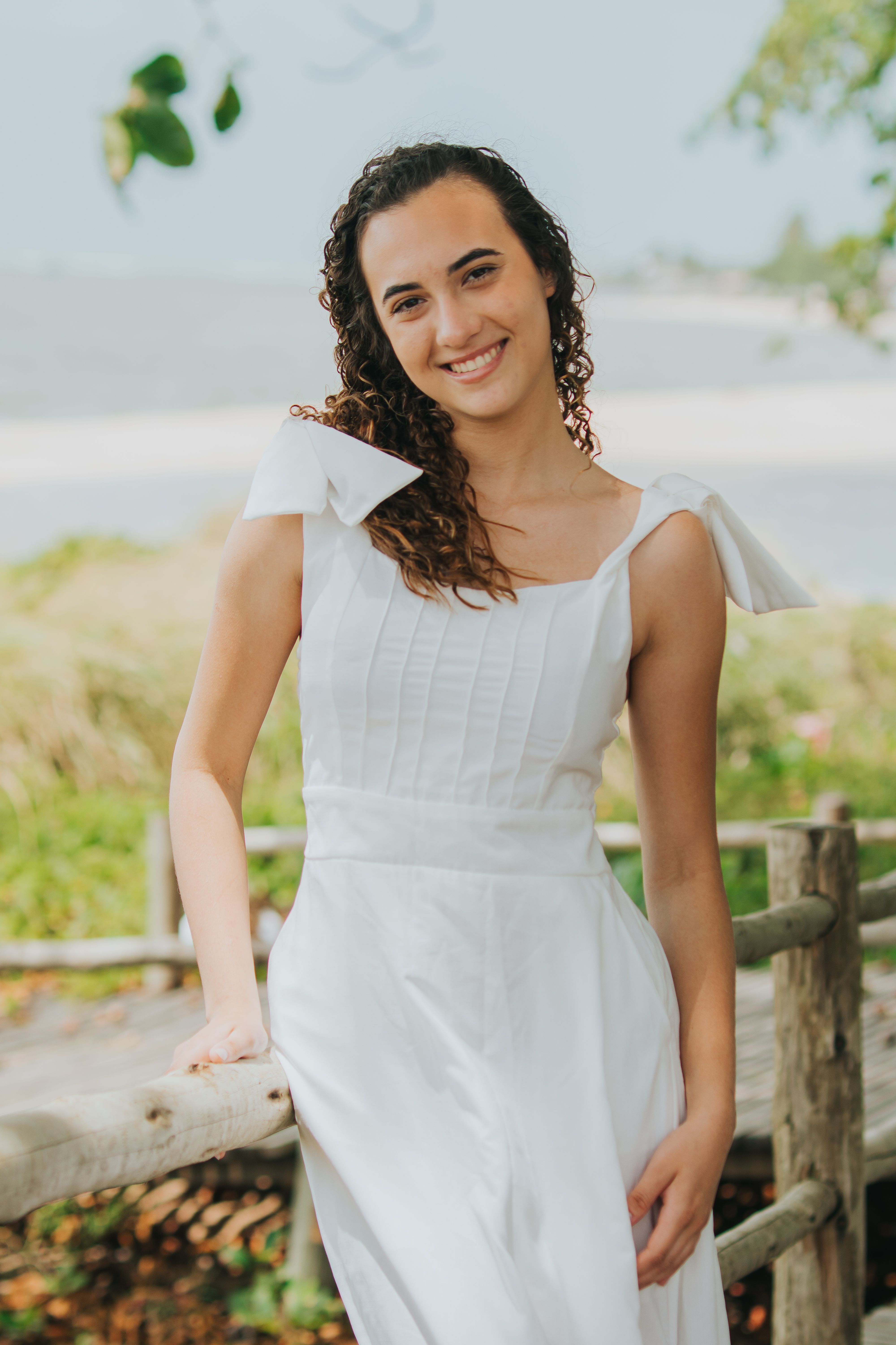 Young Woman in White Dress at Scenic Beach · Free Stock Photo